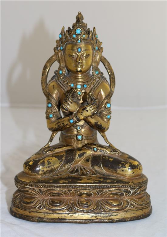 A Nepalese gilt copper alloy jewelled figure of Vajradhara, early Malla period, 15th century, height 20.3cm, later paste and stone ca